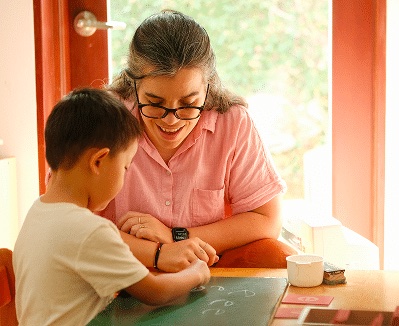 A teacher and child working together at Esara
